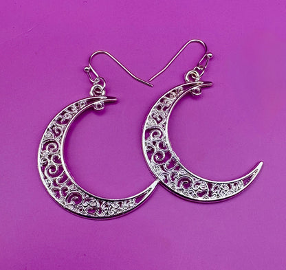 Stylish large moon earrings in gold and silver, perfect for adding a celestial touch to your jewelry collection and complementing any outfit.