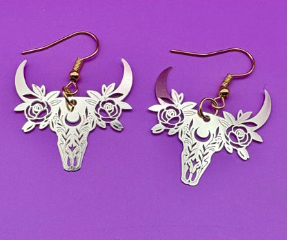 Stylish gold dangly earrings featuring a unique bull design, perfect for animal lovers and adding a bold statement to any outfit