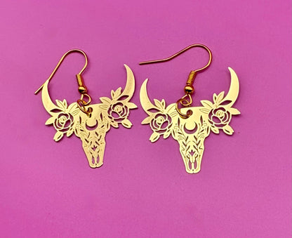 Stylish gold dangly earrings featuring a unique bull design, perfect for animal lovers and adding a bold statement to any outfit