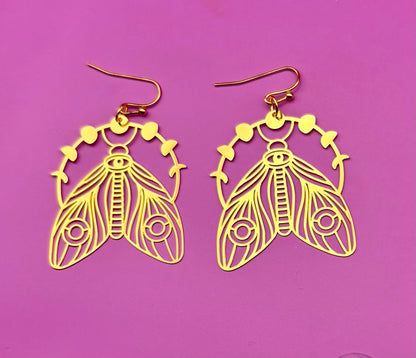 Elegant gold moth dangly earrings, featuring intricate design and lightweight construction, perfect for adding a unique touch to any outfit.