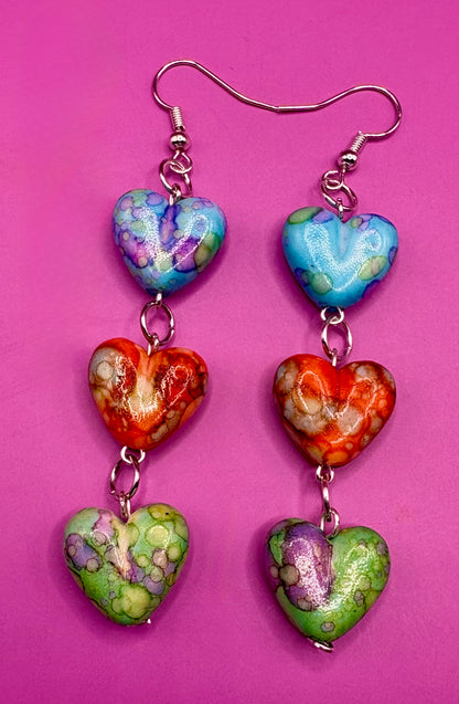 Elegant long dangly drop earrings featuring marble heart-shaped resin designs, ideal for enhancing your outfit with a chic and modern accessory for any event.
