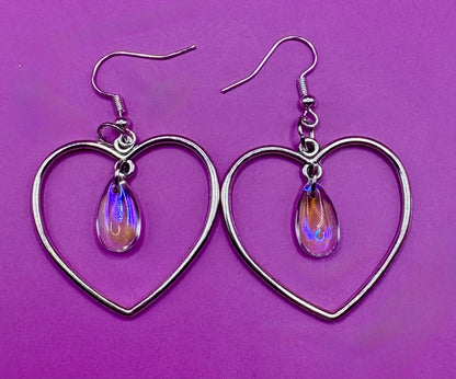 Stylish silver heart hoop dangly earrings, featuring a trendy design perfect for adding a romantic touch to any outfit.