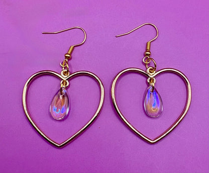 Stylish silver heart hoop dangly earrings, featuring a trendy design perfect for adding a romantic touch to any outfit.