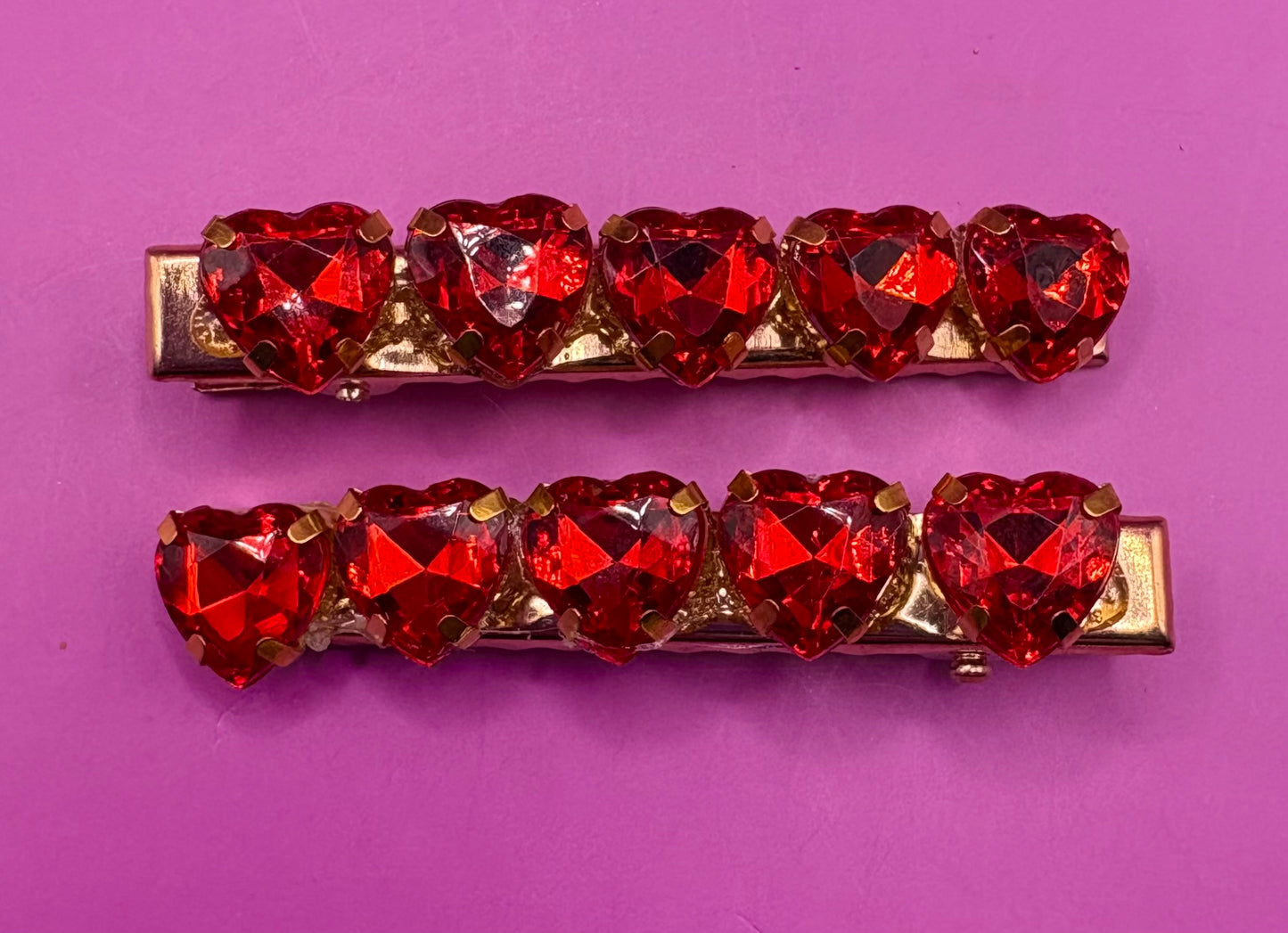 Charming small heart-shaped earrings adorned with sparkling rhinestones, ideal for adding a touch of glam to any outfit or as a gift for loved ones.