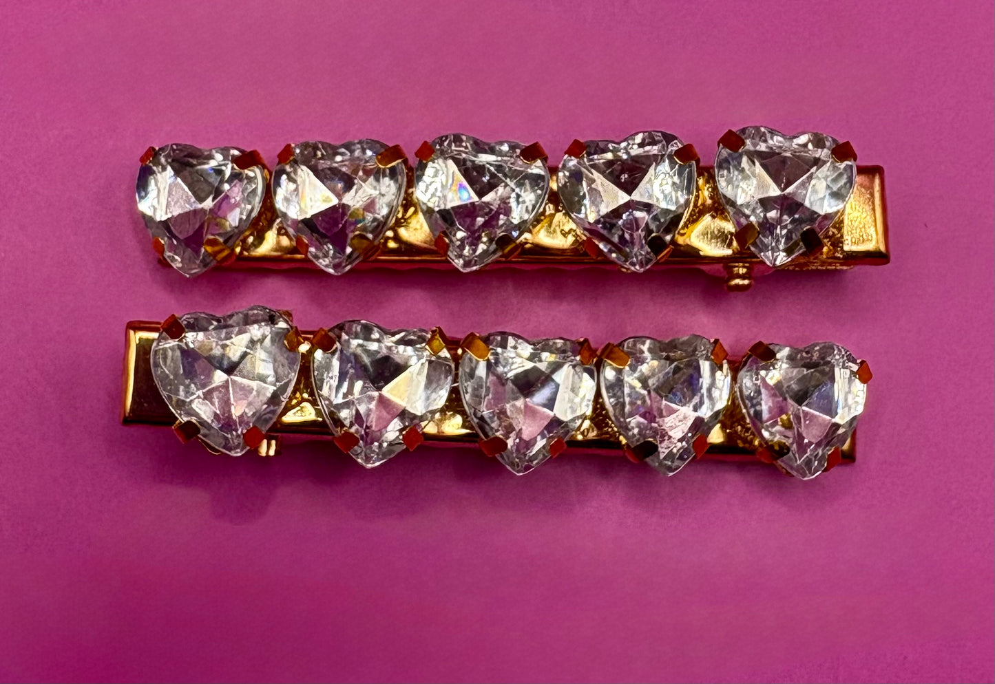 Charming small heart-shaped earrings adorned with sparkling rhinestones, ideal for adding a touch of glam to any outfit or as a gift for loved ones.
