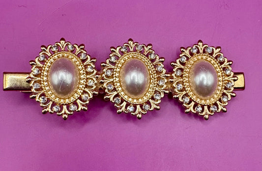 Elegant gold oval hair clip featuring pearl-style embellishments and sparkling rhinestones, measuring 8cm long, perfect for making a statement in any hairstyle for special occasions or everyday wear.