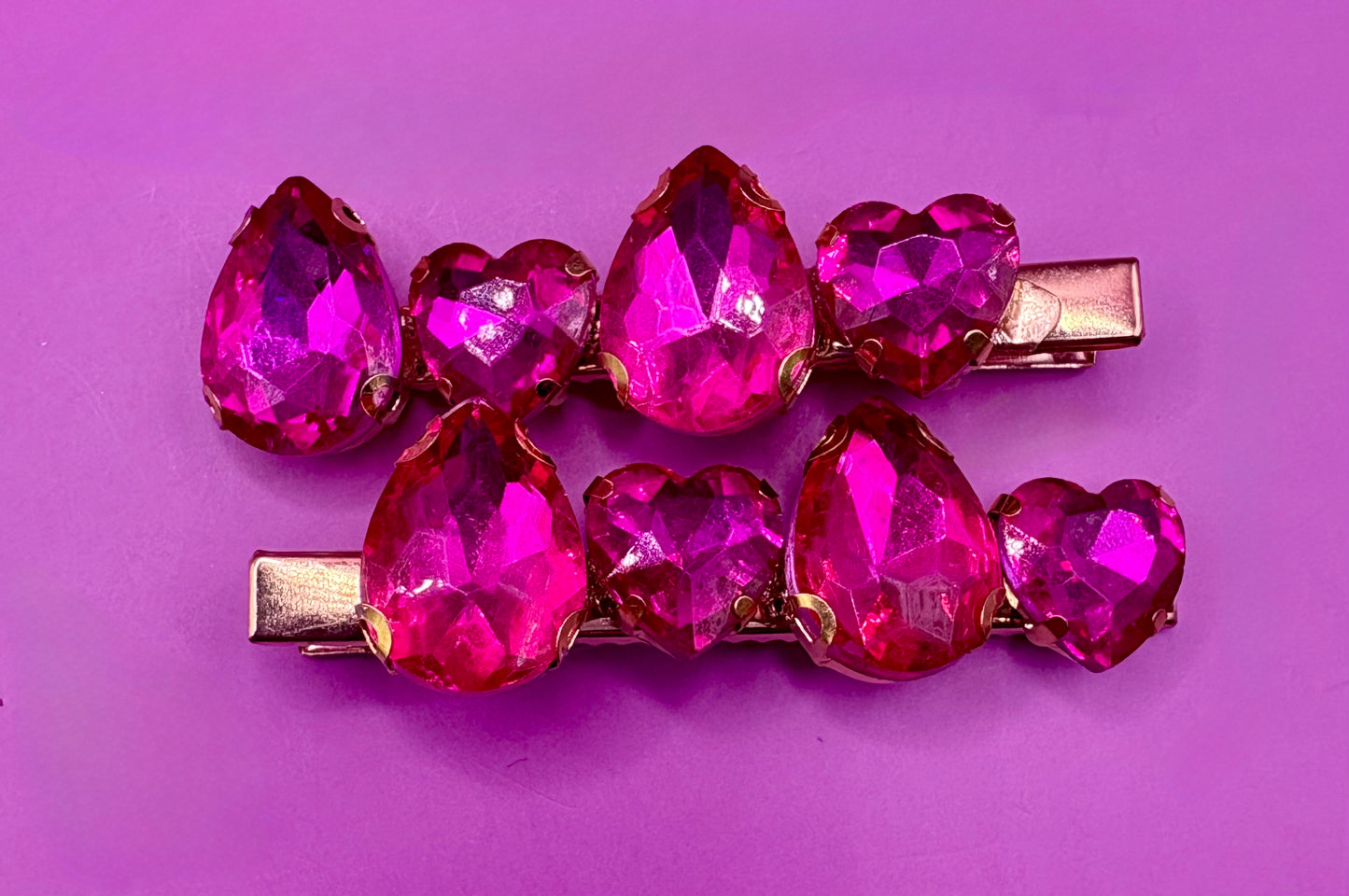Elegant pair of pink and purple gemstone hair slides, ideal for enhancing your hairstyle with a touch of glamour and color.