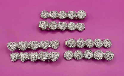 Charming heart-shaped circular glitter hair slides in silver, perfect for festive hairstyles and holiday parties, sold in pairs, each measuring 6cm.