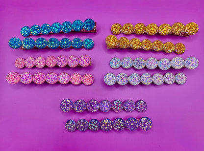 Chic large circular glitter heart hair clips, featuring a sparkly design and sold as a pair, ideal for Valentine's Day gifts and enhancing any hairstyle with a touch of glamour. available in multi colour, gold, turquois pink silver purple