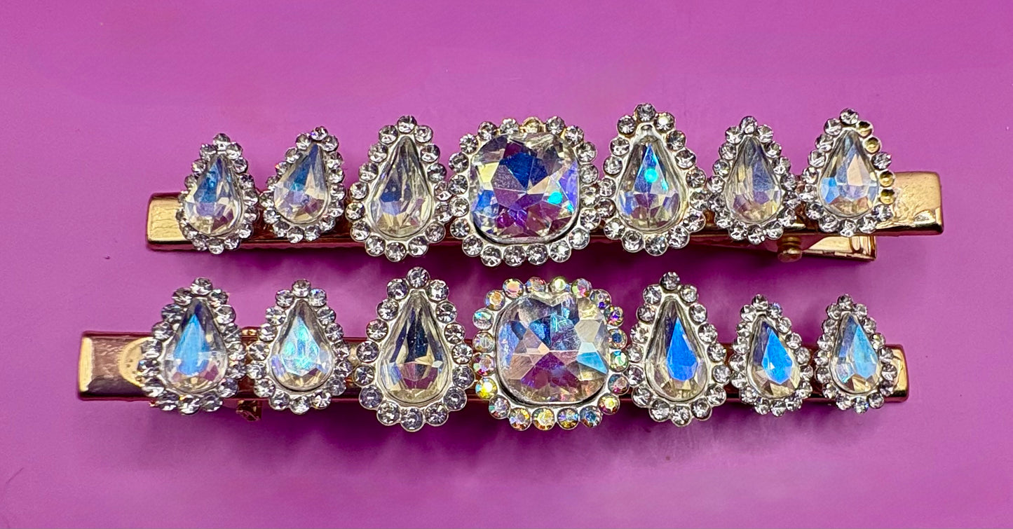 Fashionable silver hair clip featuring unique heart and circular designs embellished with colorful gemstones.