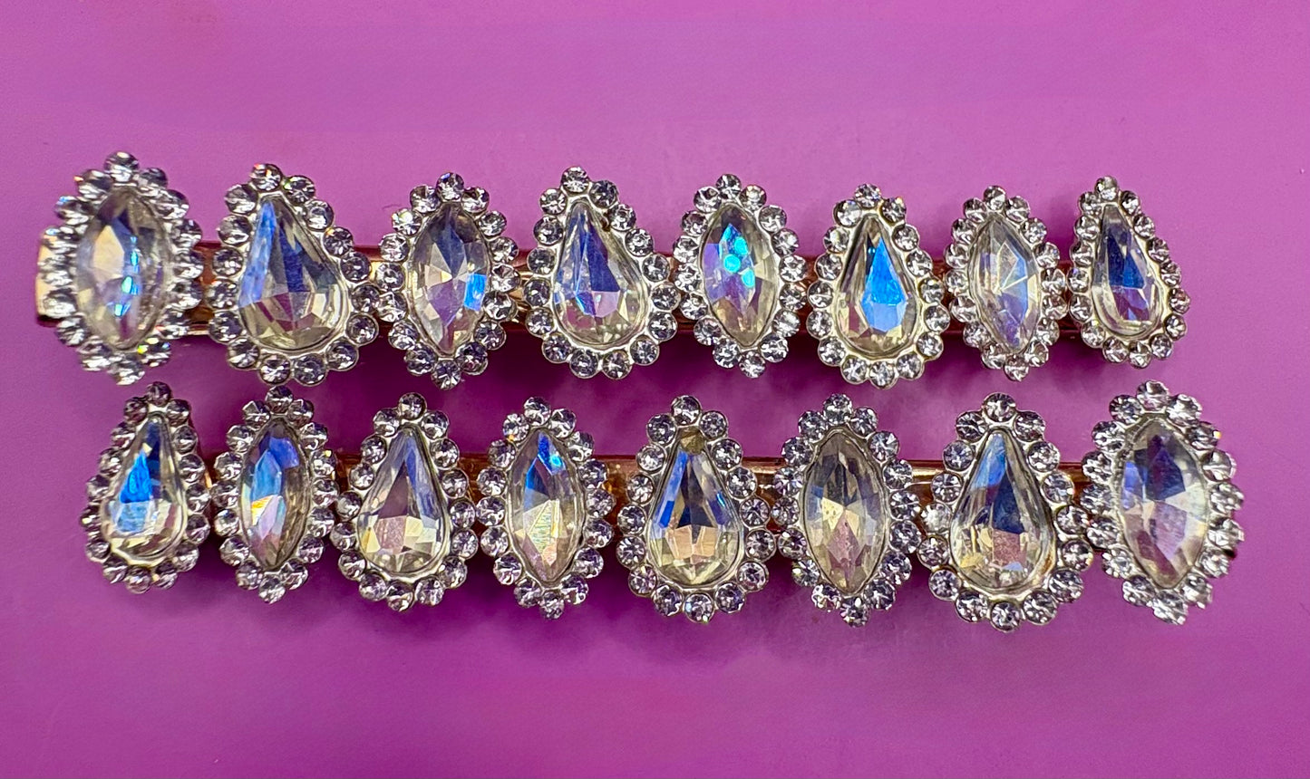 Fashionable silver hair clip featuring unique heart and circular designs embellished with colorful gemstones.