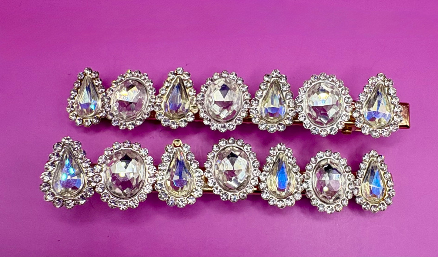 Fashionable silver hair clip featuring unique heart and circular designs embellished with colorful gemstones.