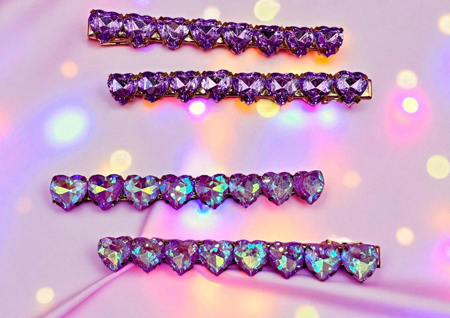 Set of purple heart-shaped jewelry on a colorful blurred background