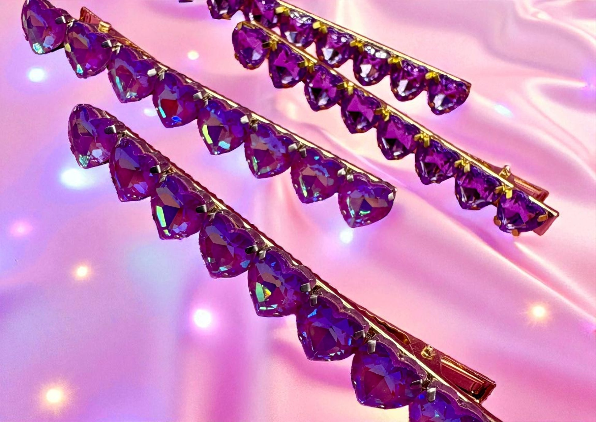 Purple crystal hair clips on a pink background