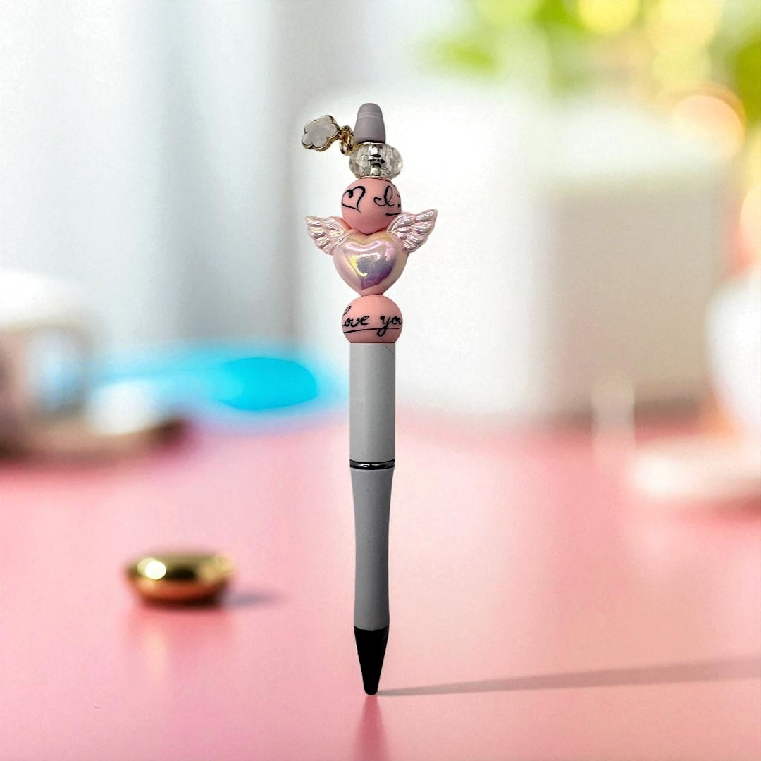 Pen with angel-shaped top on a blurred background