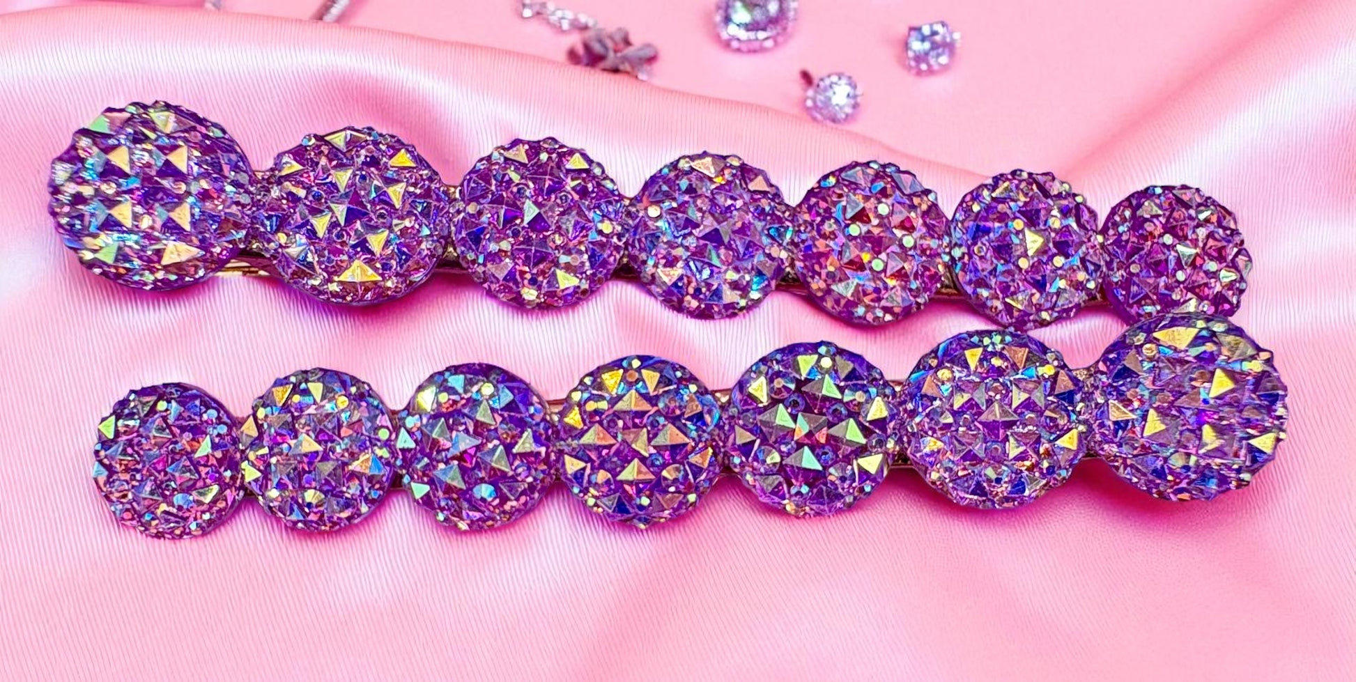 Purple and pink round gemstones hair clips  on a pink background