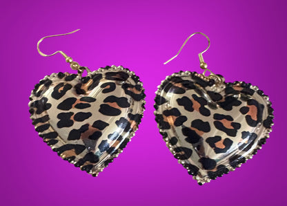 Stylish dangly earrings featuring a heart pendant design in chic leopard print, perfect for adding a touch of wild elegance to your jewelry collection and enhancing any outfit.
