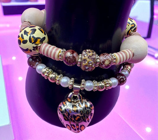 Multicolored beaded bracelets on a black mannequin against a purple background