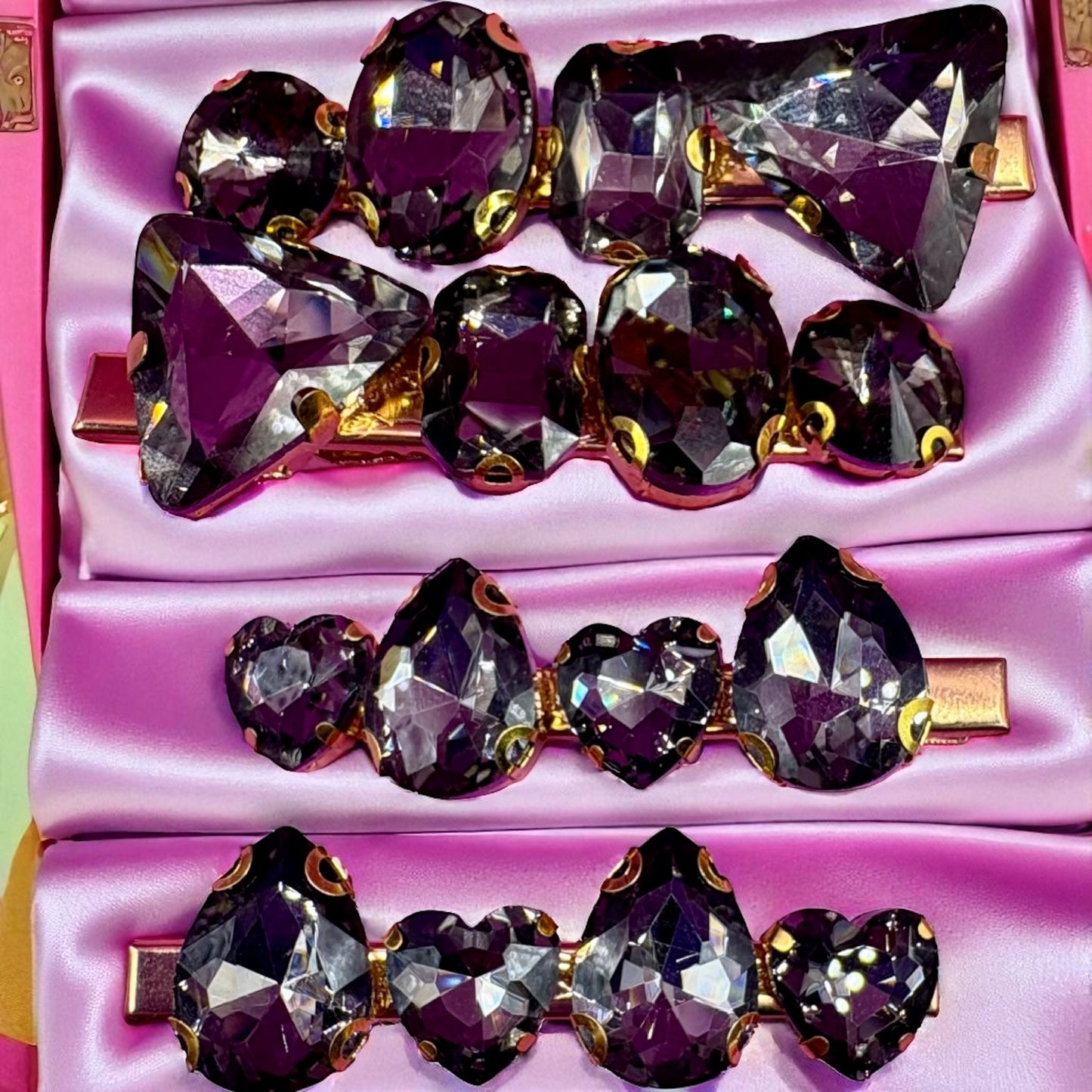 Set of purple crystal hair clips in a pink box