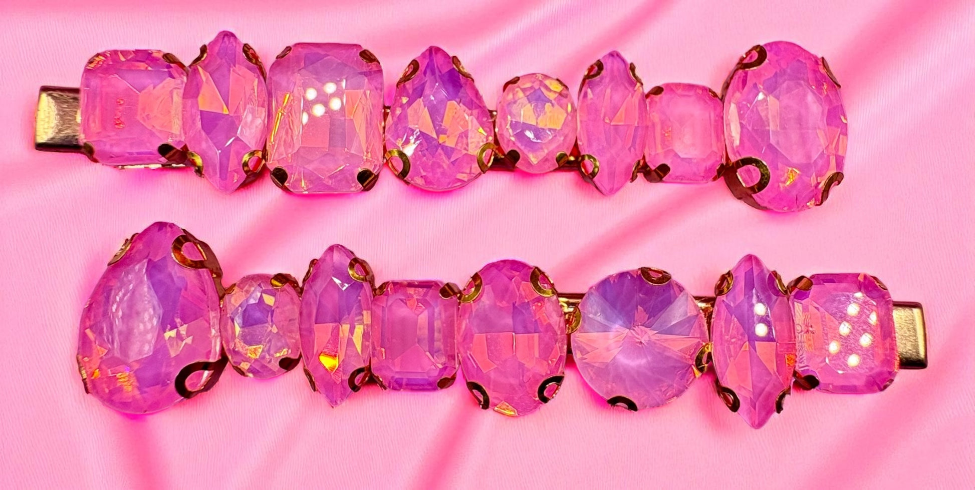 Pink gemstone hair clips on a pink background
