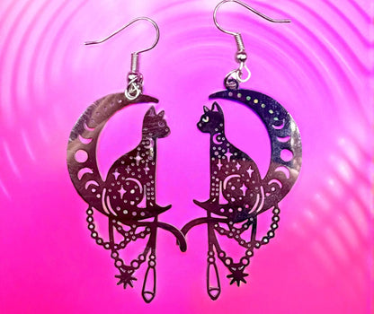 Cat and moon earrings on a pink and purple gradient background