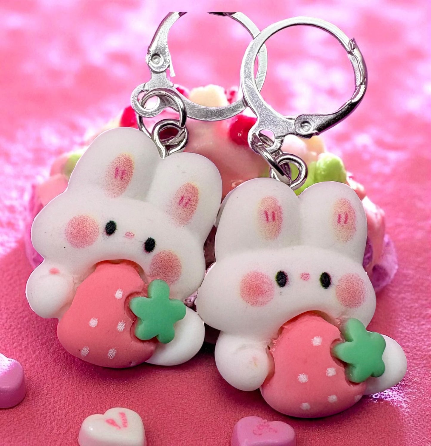 Cute bunny keychains with strawberry designs on a pink background