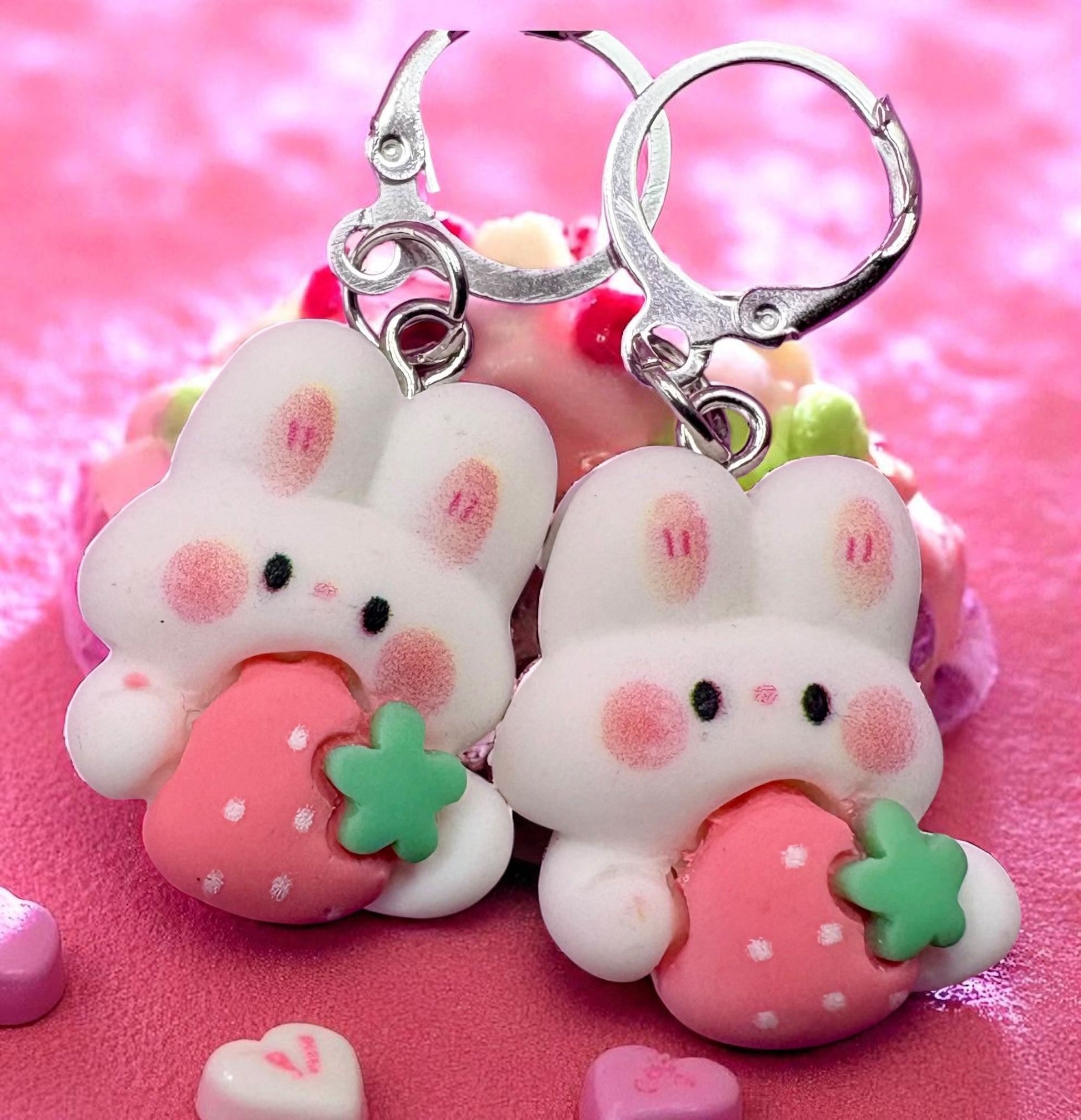 Cute bunny keychains with strawberry designs on a pink background