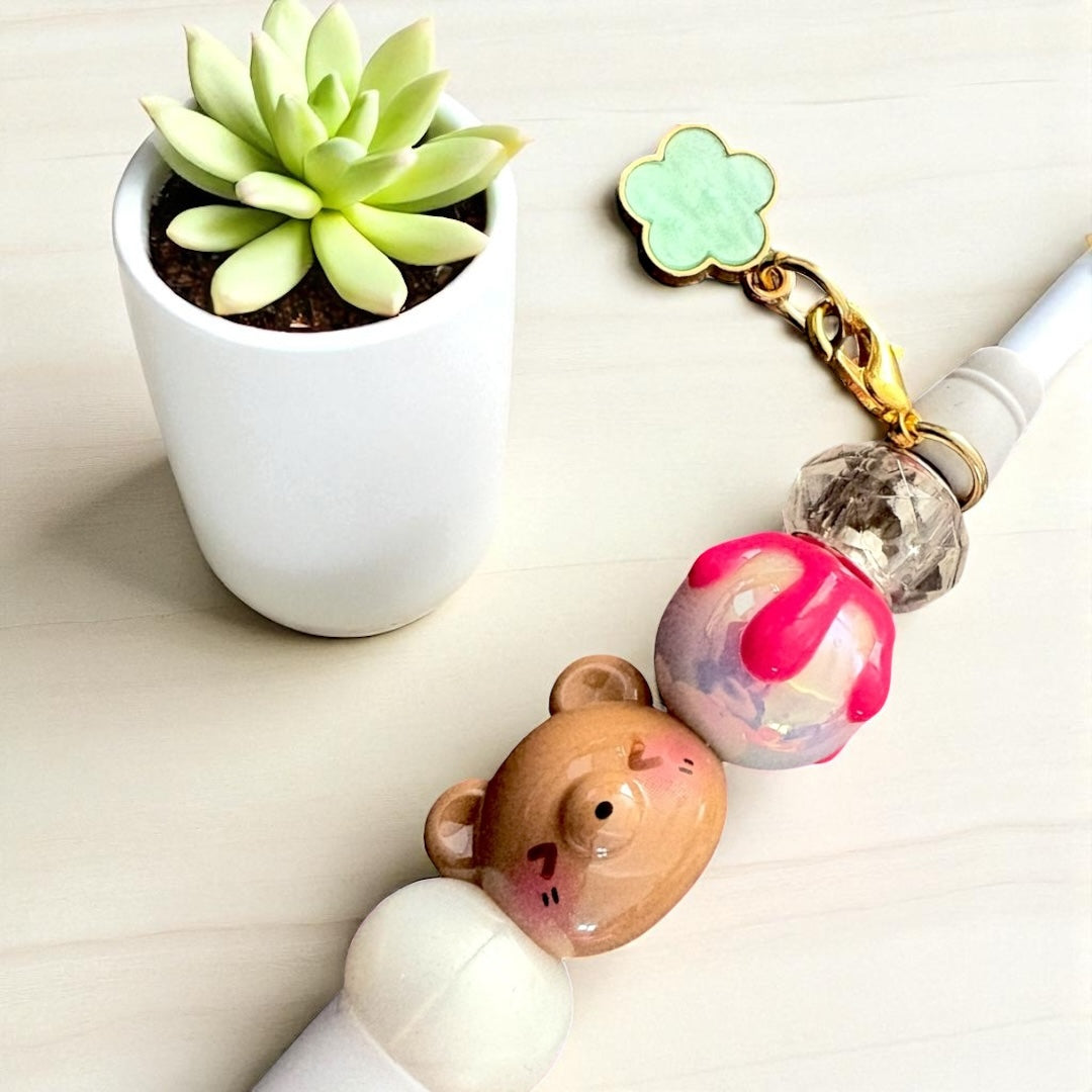 Handcrafted black ballpoint pens with adorable gummy bear and teddy bear charms.