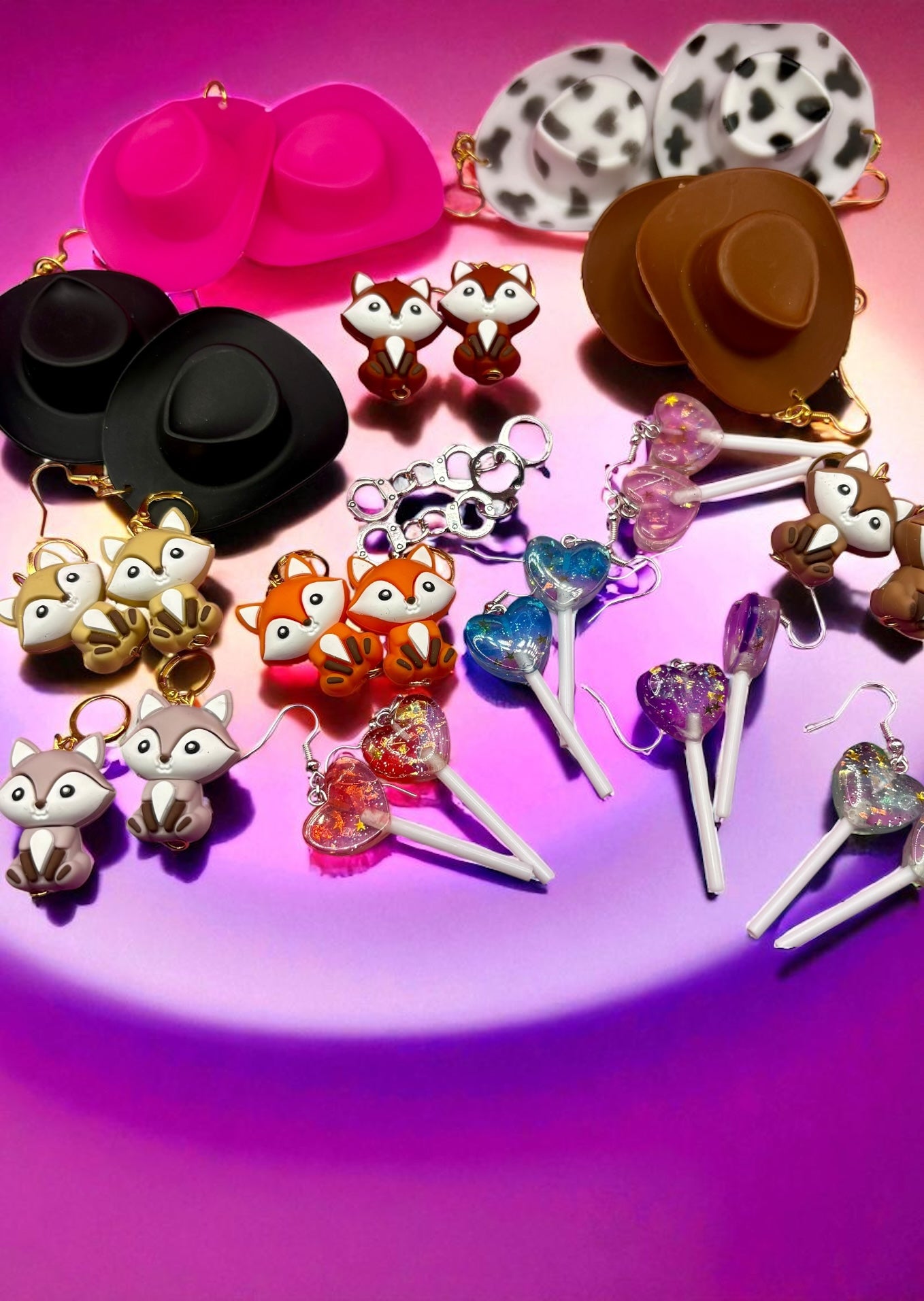 Collection of colorful   earrings on a pink background