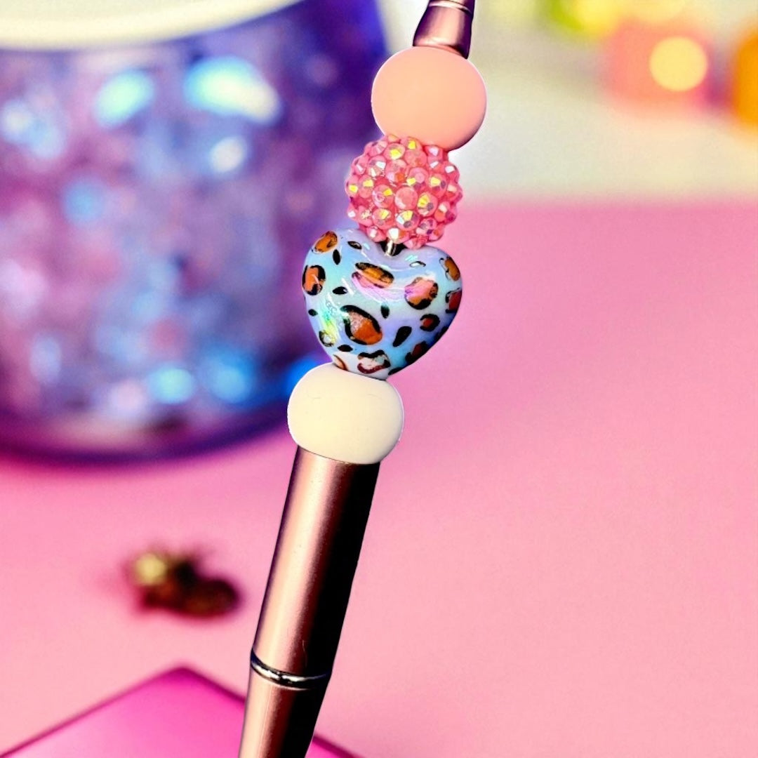 Makeup brush with decorative handle on a pink background