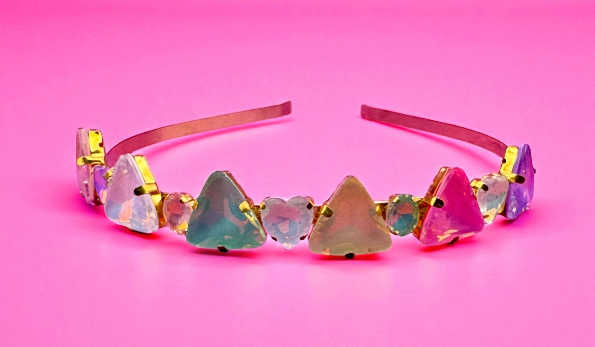 Multicolored gemstone headband on a pink background