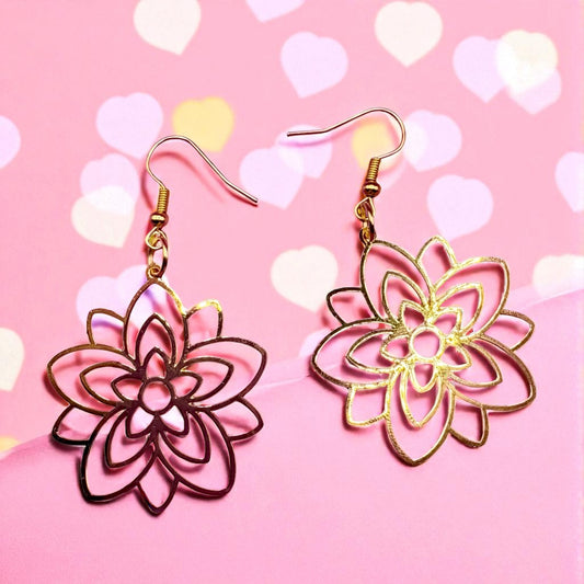 Floral earrings on a pink background with heart shapes