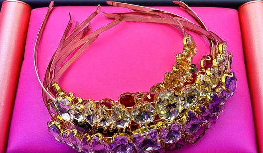 Decorative headband with colorful gemstones on a pink background