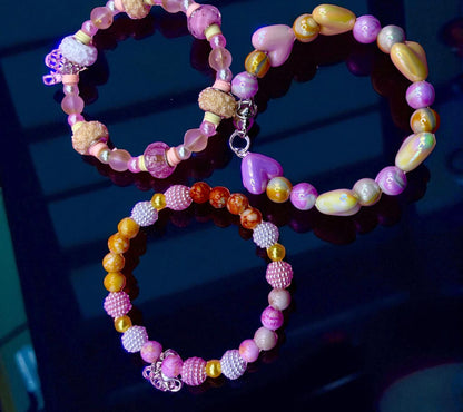 Colorful beaded bracelets on a dark surface