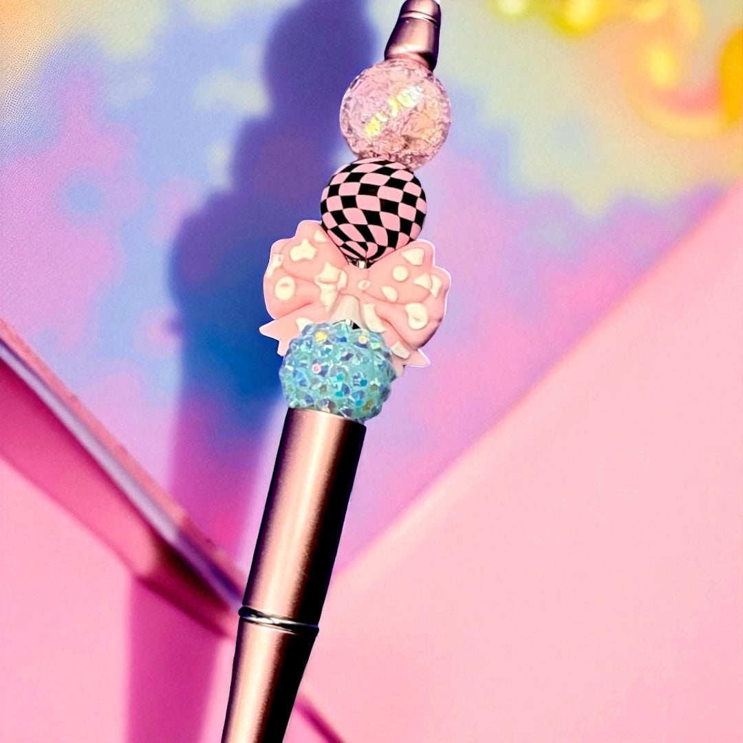 Decorative pen with colorful beads on a multicolored background