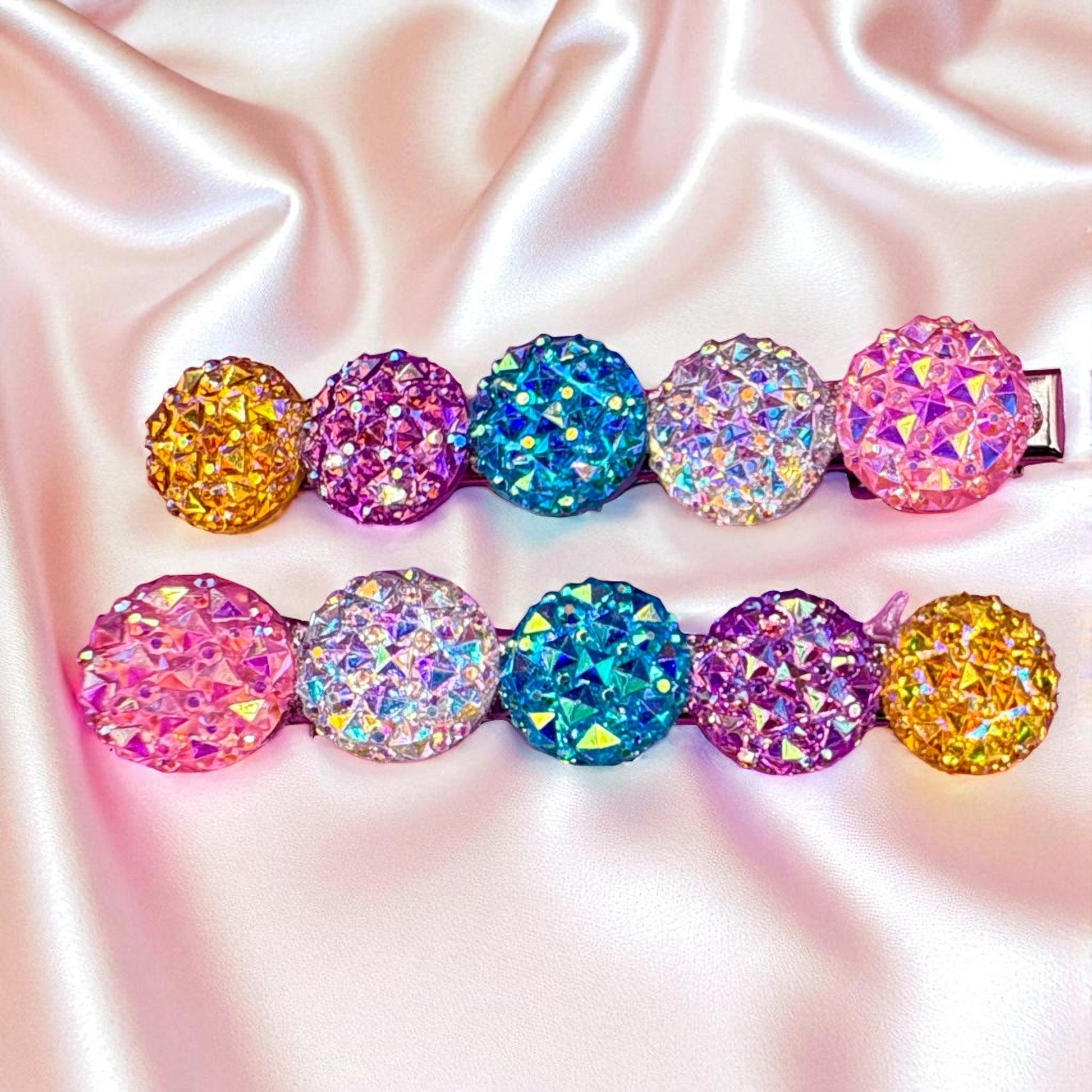 Colorful crystal hair clips on a satin background