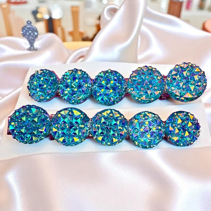 Set of blue rhinestone hair clips  on a white surface