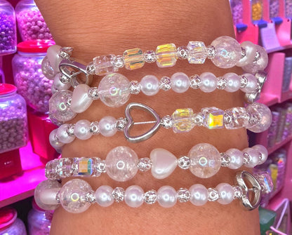 Stack of beaded bracelets on a wrist with a colorful background