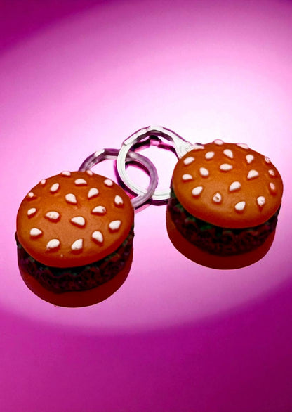 Hamburger-shaped  earrings on a pink background