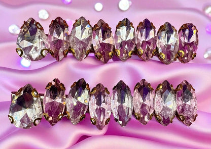 Row of sparkling gemstones on a pink textured background