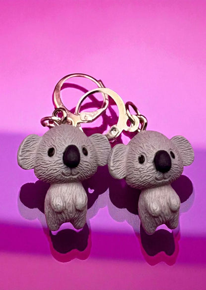 Pair of koala keychains on a pink background
