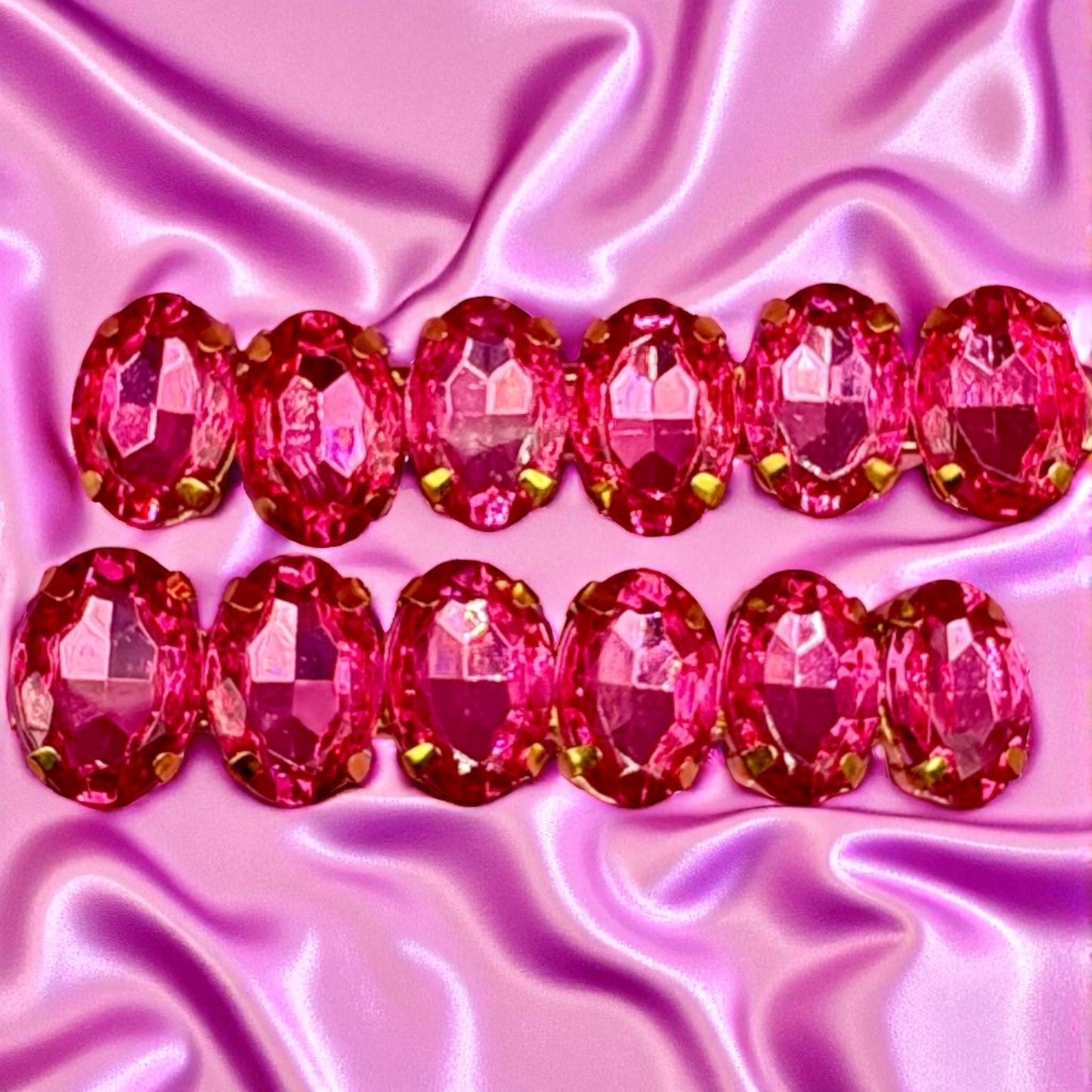 Pink gemstones on a pink satin background