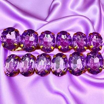 Purple beaded bracelet on a purple satin background