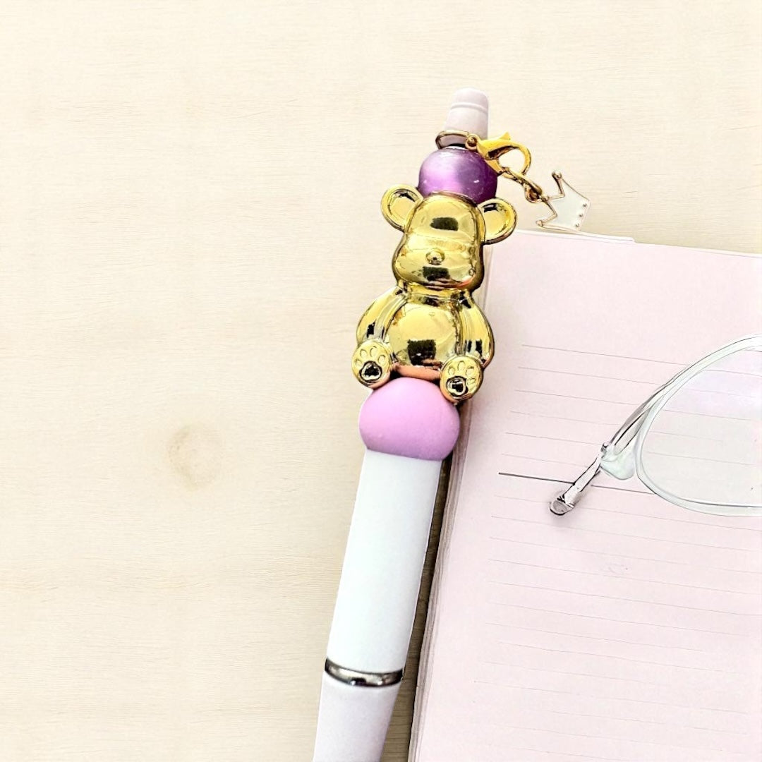 Handcrafted black ballpoint pens with adorable gummy bear and teddy bear charms.