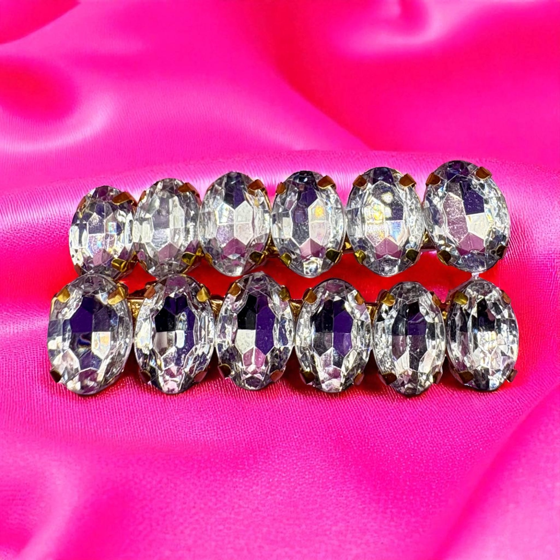 Row of crystal-like beads on a pink background