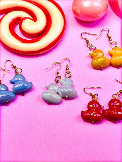 Colorful earrings on a pink background