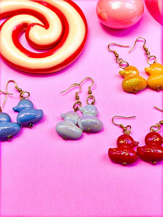 Colorful earrings on a pink background