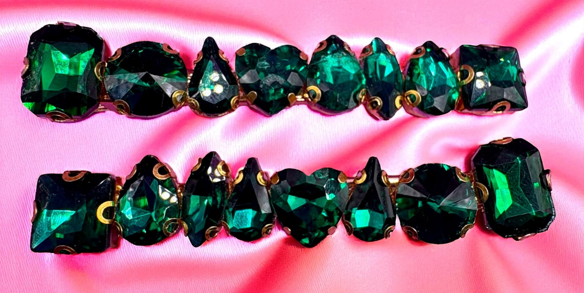 Green gemstone bracelet on a pink background