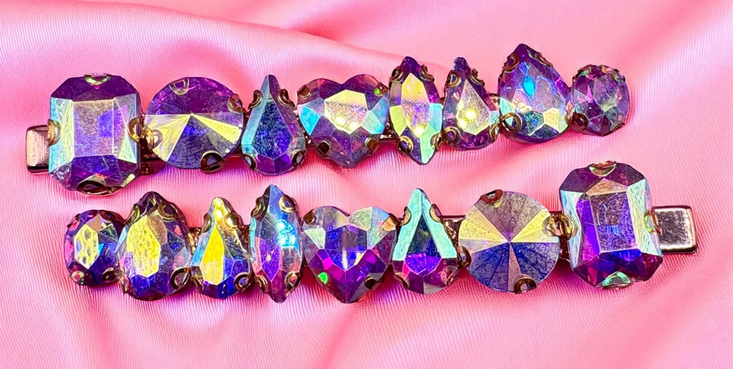 Multicolored gemstone hair clips on a pink background
