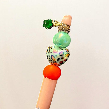Colorful pen top with decorative beads on a light background